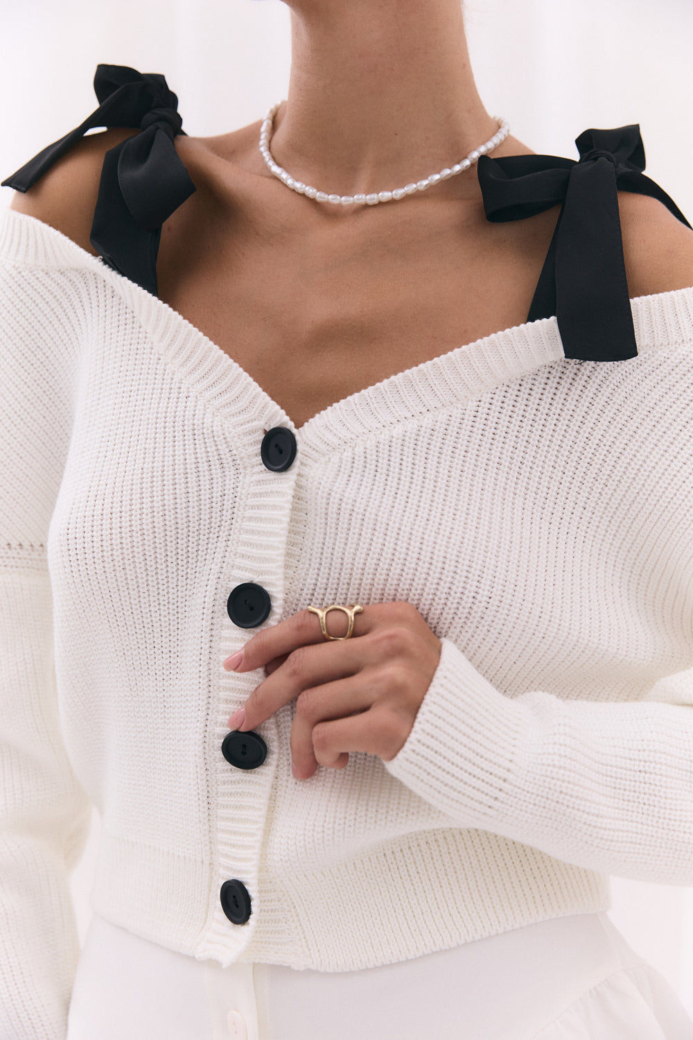 White knitted cardigan with shoulder straps