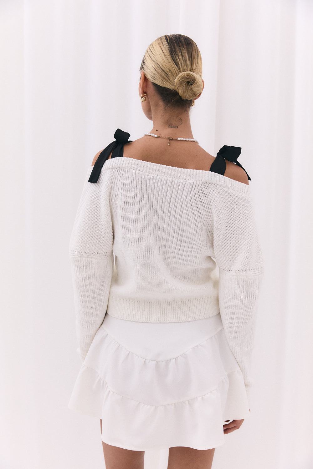 White knitted cardigan with shoulder straps