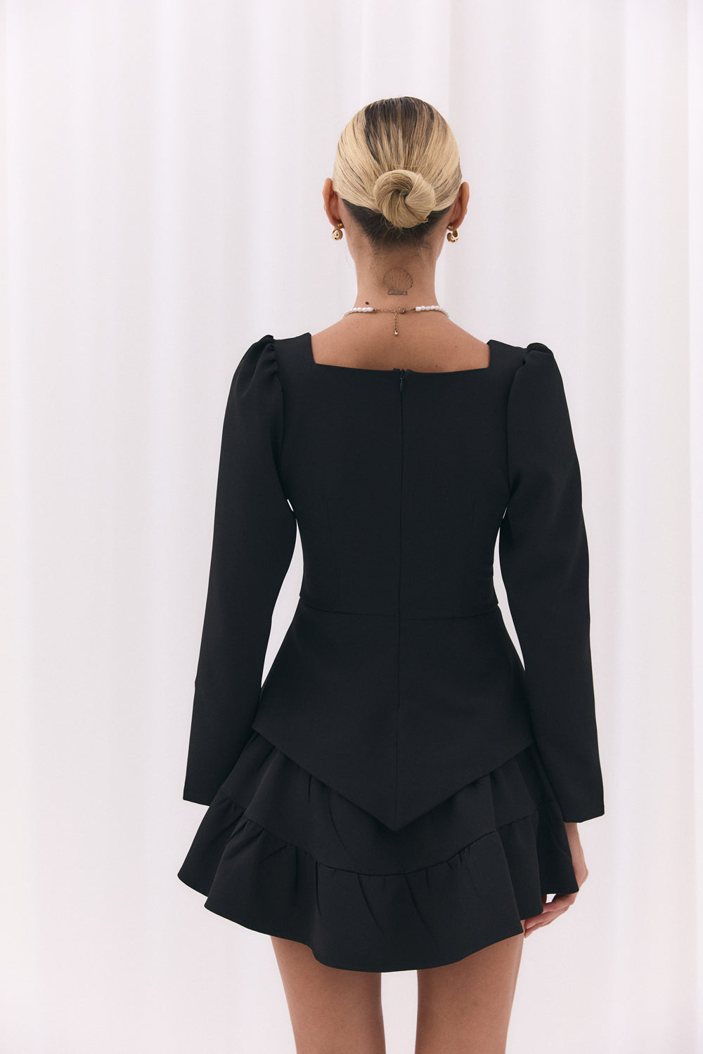 Black blouse with a figured peplum