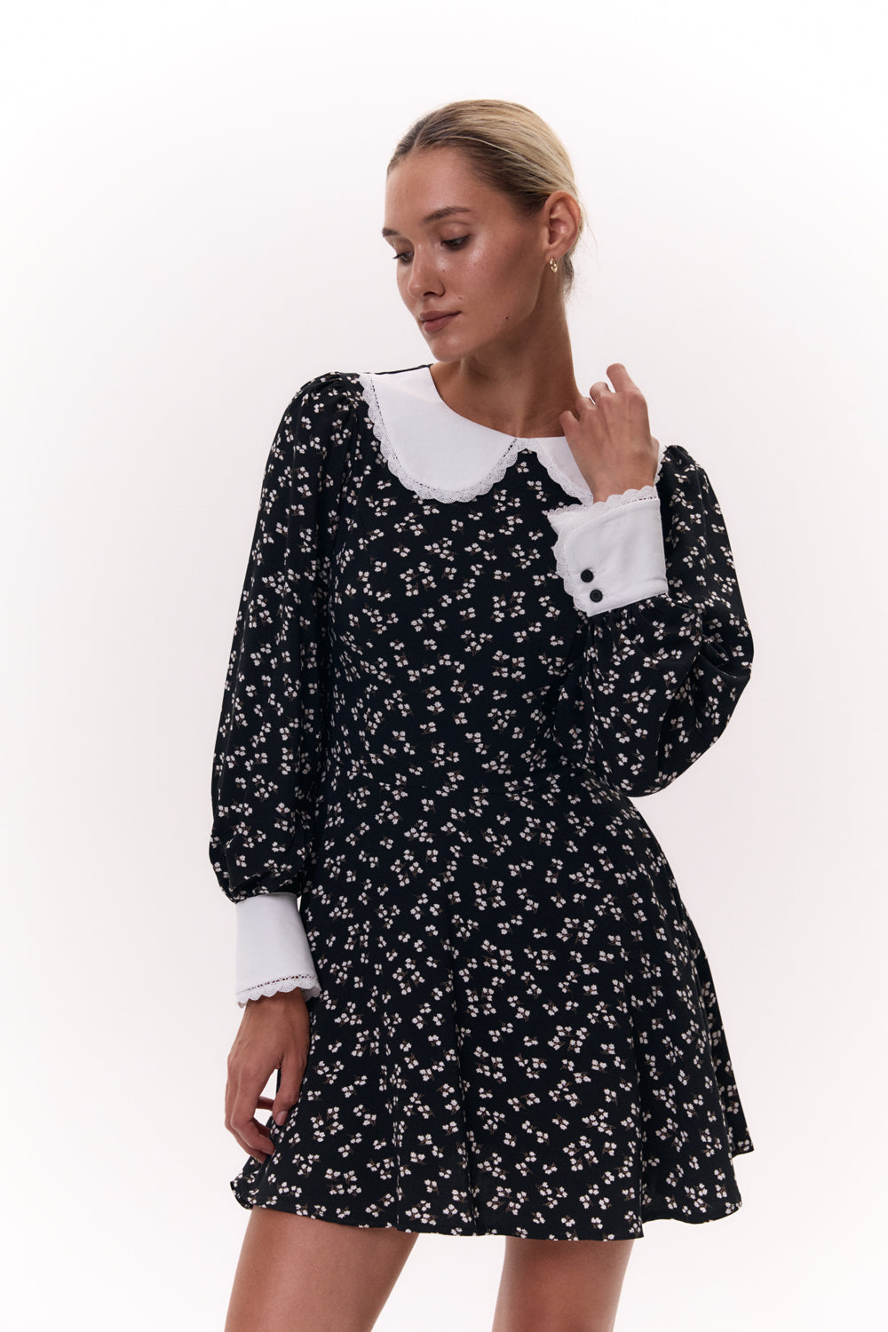 Black semi-fitted dress with a half-sun skirt and puffy cuffed sleeves