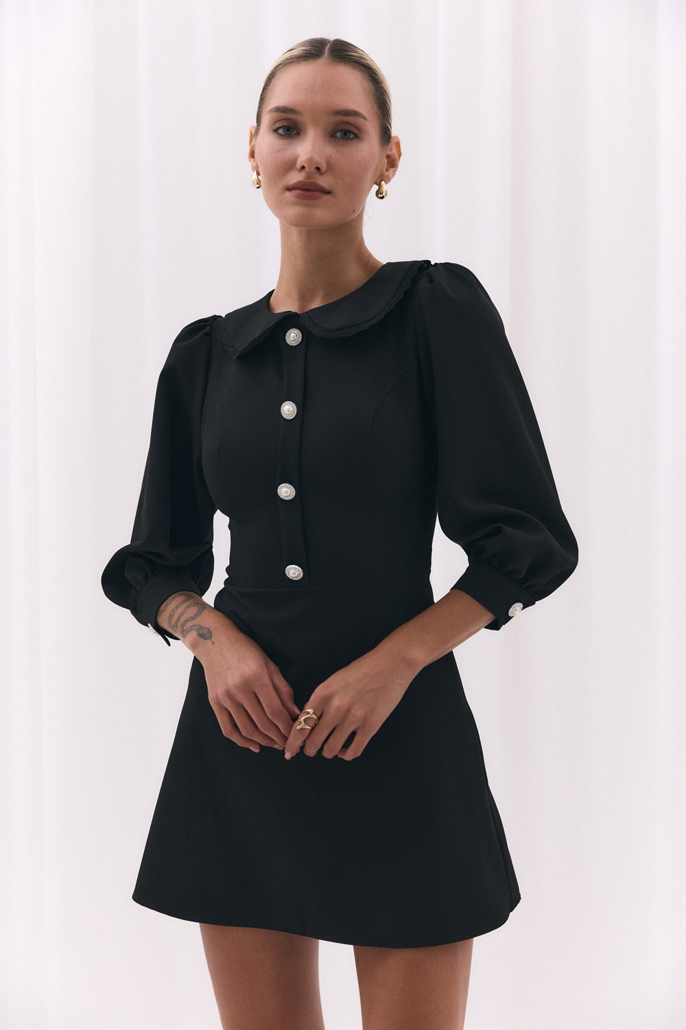 Black fitted dress with a-line skirt and lace collar