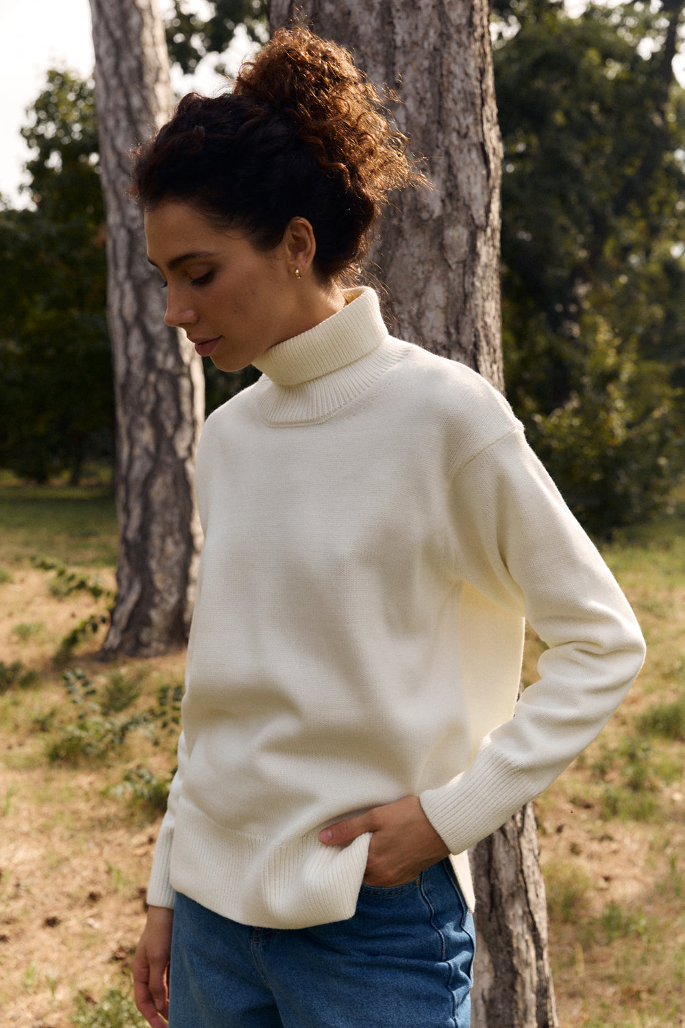 Milk sweater with a high collar and side slits