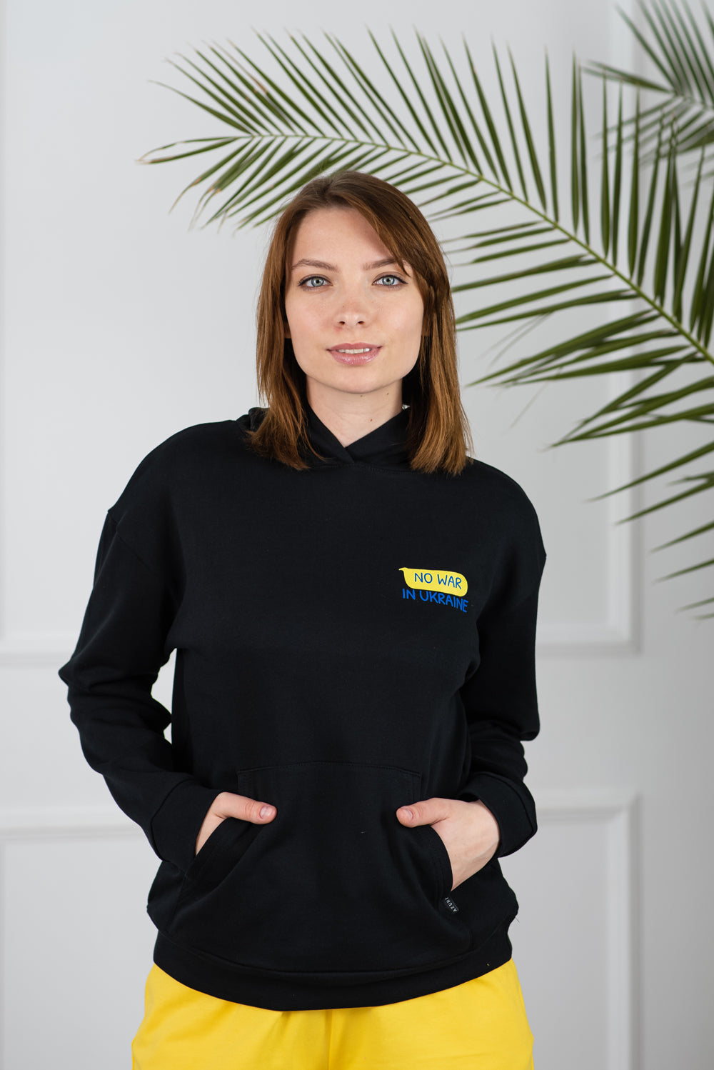 Stylish women's hoodie black "No war in Ukraine"