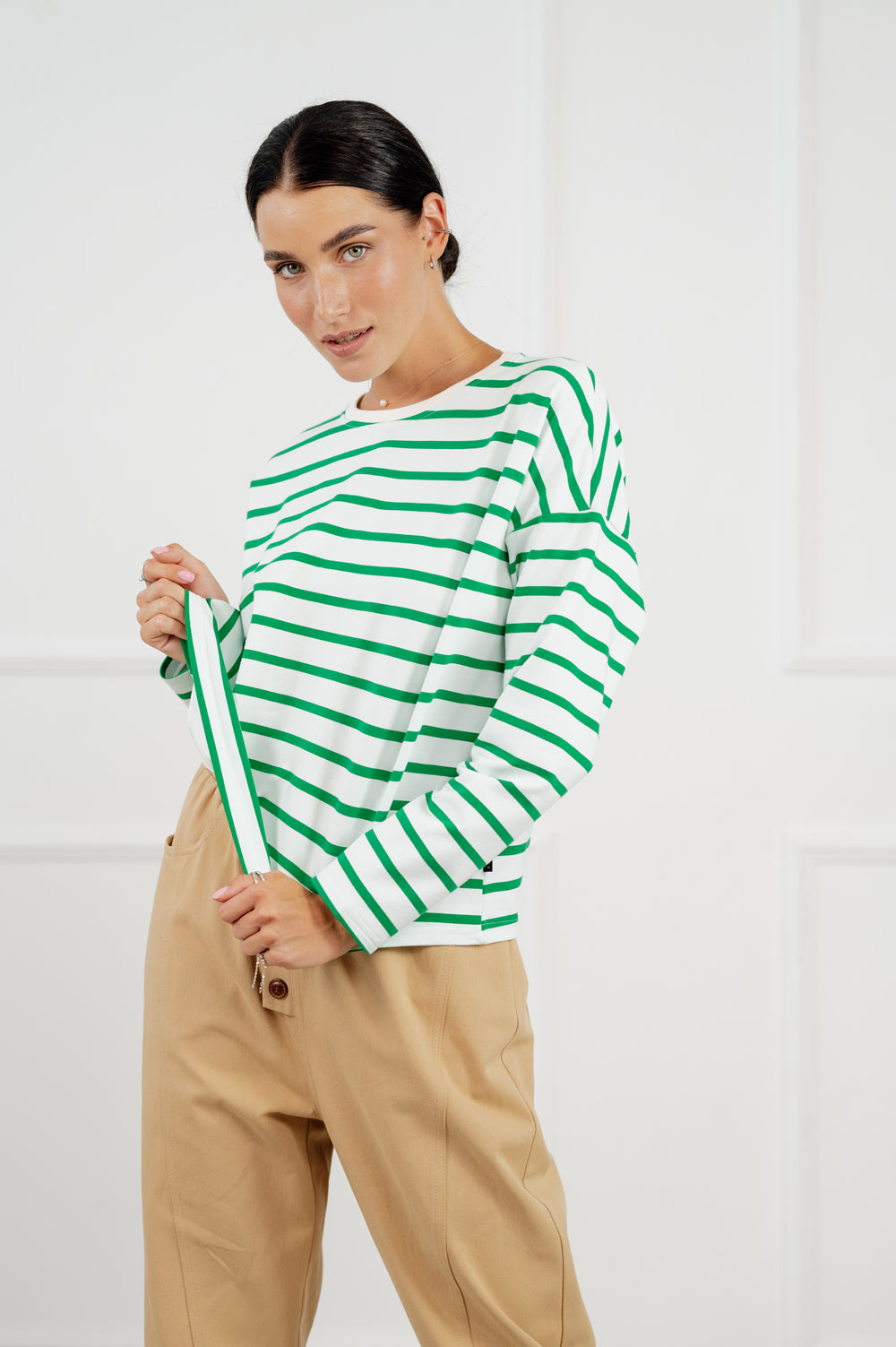 Green cropped sweatshirt with stripes.