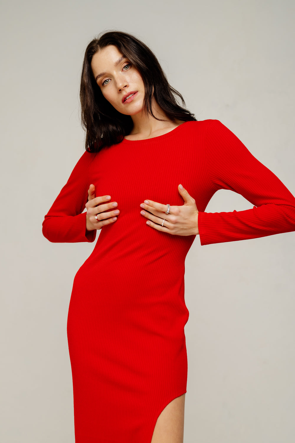 Red midi length dress with an elegant cutout on the left.