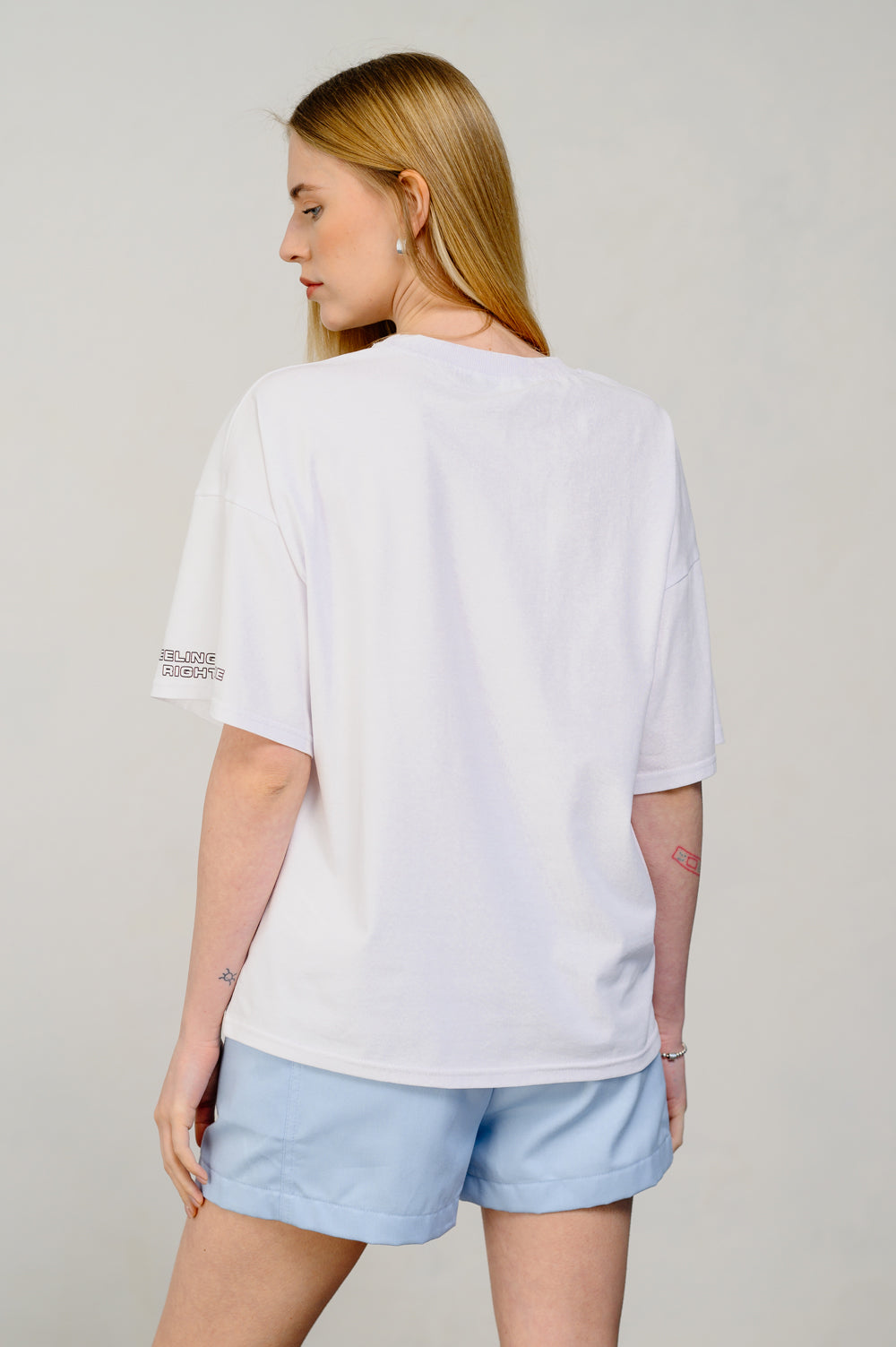 Oversized white T-shirt with sticker