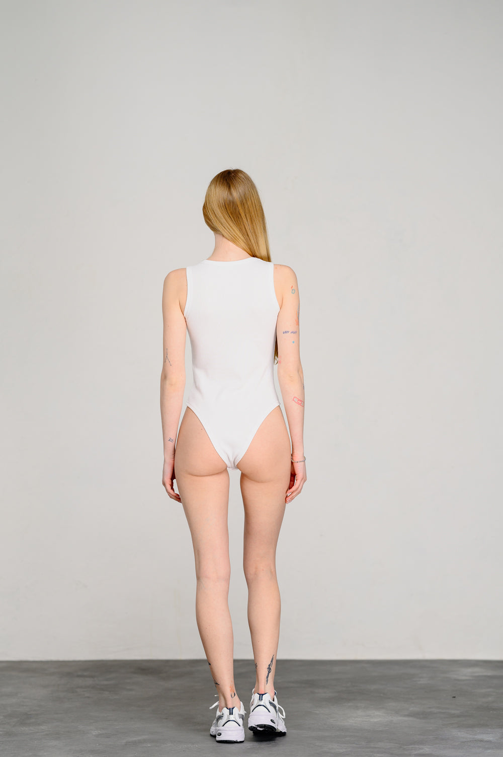 White stylish bodysuit with a figured neckline