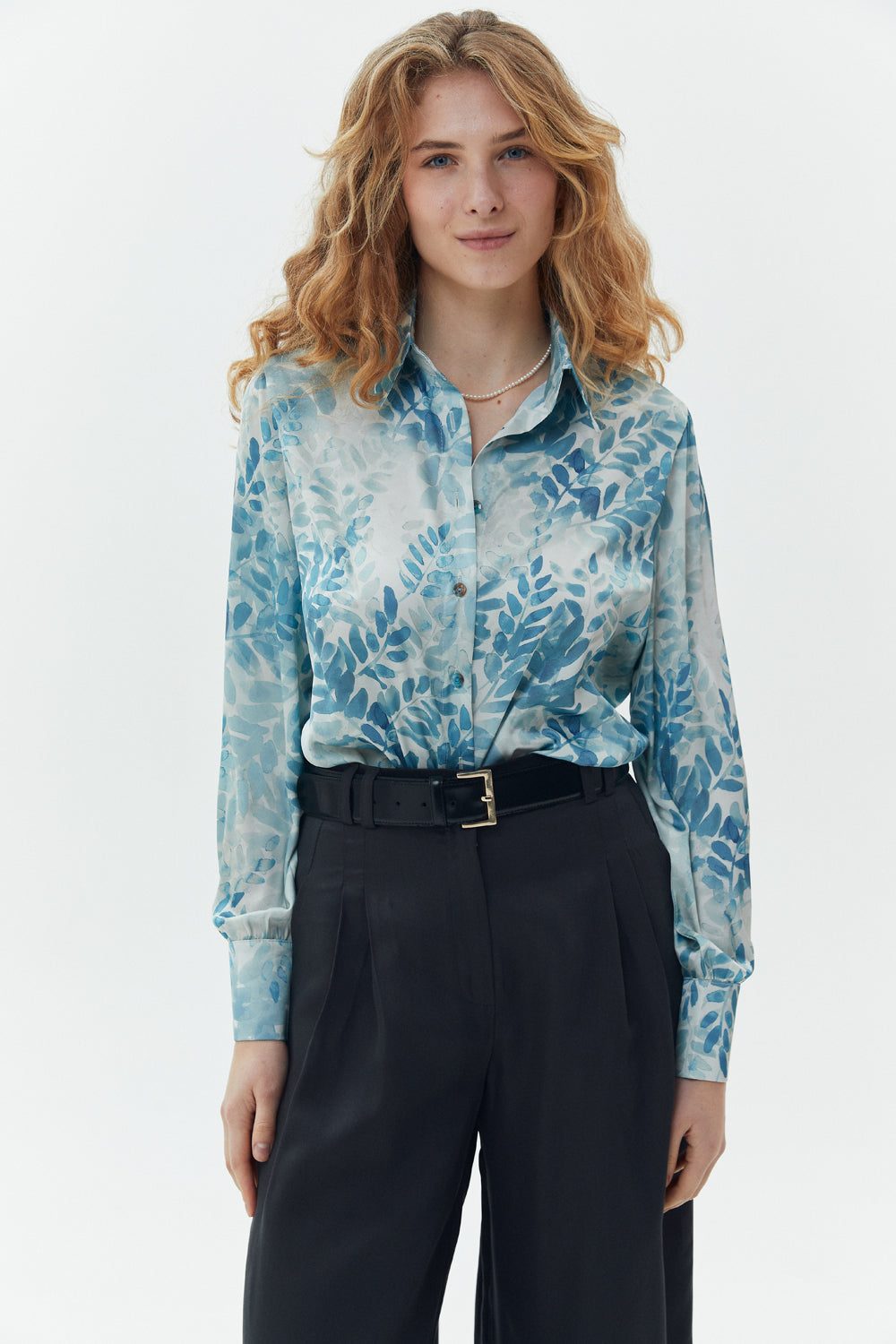 Elegant loose-fitting turquoise blouse