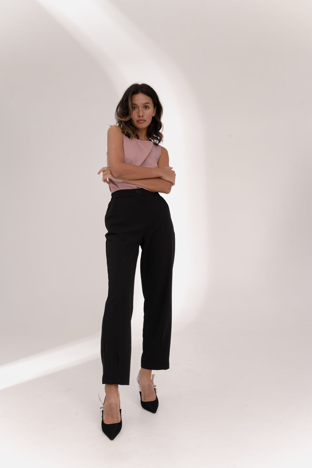 Black trousers with an elasticated waistband and pleats at the hem