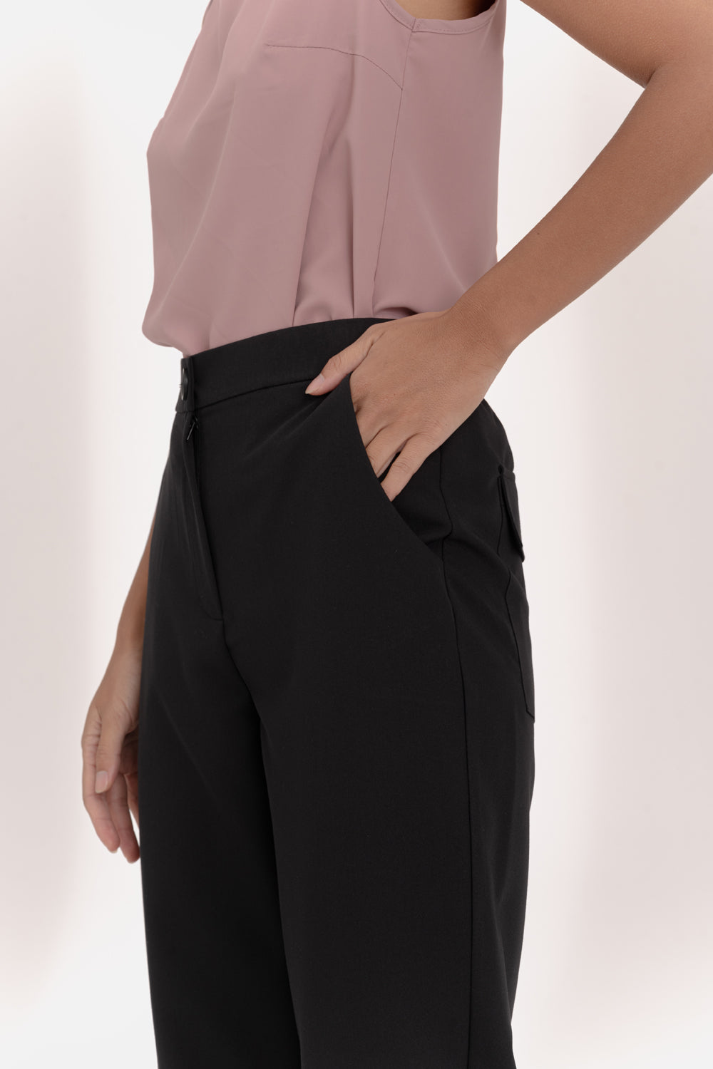 Black trousers with an elasticated waistband and pleats at the hem